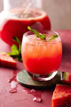 a drink with watermelon and mint garnish