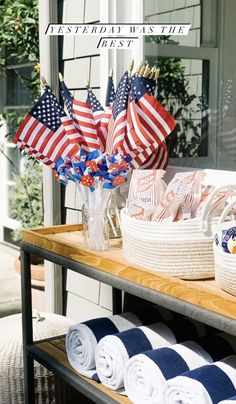 an outdoor display with american flags and towels