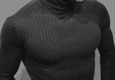 a man wearing a turtle neck sweater with a dog on his shoulder