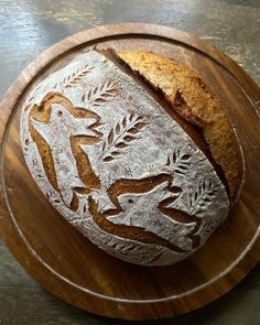 a loaf of bread sitting on top of a wooden plate