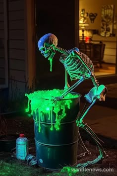 a skeleton sitting on top of a bucket filled with green liquid