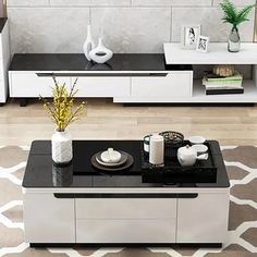 a black and white coffee table in the middle of a living room with modern furniture