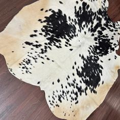 a cowhide rug with black and white spots