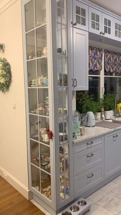 a kitchen filled with lots of counter top space and cupboards next to a window