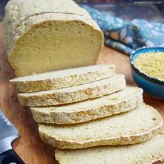 sliced loaf of bread sitting on top of a wooden cutting board