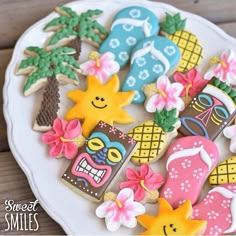 decorated cookies on a plate with pineapples, flip flops and sunflowers