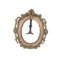 an old fashioned pink and gold frame with a clock on the front, hanging from it's side