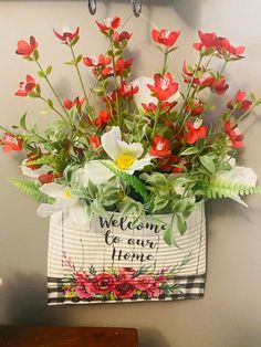 a basket with flowers hanging on the wall