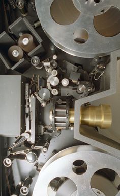 the inside of a machine that has many different types of metal parts on it's sides