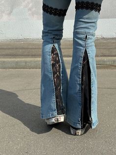 the legs of a person wearing jeans with lace on them