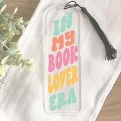 a towel with the words i'm my book lover era on it next to a potted plant