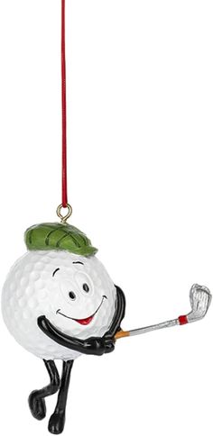 a golf ball ornament hanging from a red string with a green hat on it