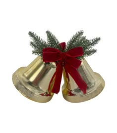 two bells with red bows on them and a pine branch sticking out of the top