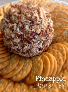 crackers and cheese ball sitting on top of a plate