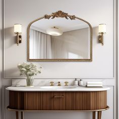 a bathroom vanity with a mirror above it and flowers on the counter top in front of it