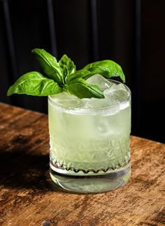 a green drink sitting on top of a wooden table