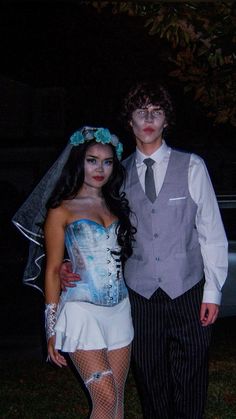 a man and woman dressed up in costumes