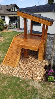 a wooden bench sitting in the middle of a yard