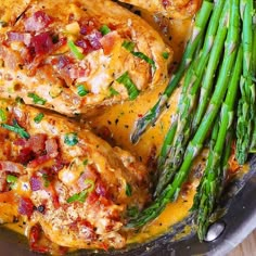 some chicken and asparagus are in a skillet