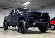 a large black truck parked in a garage