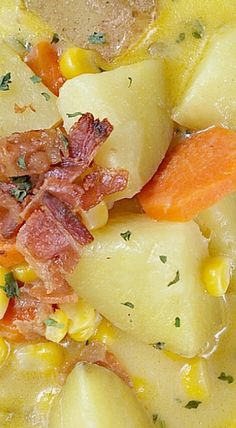 a close up of food on a plate with corn and carrots in the background