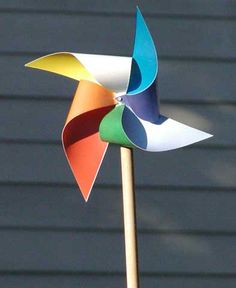 a colorful pinwheel sitting on top of a wooden stick