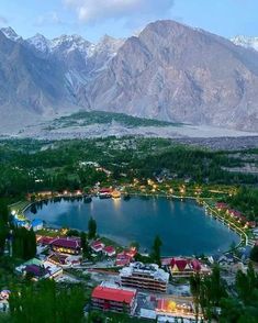 an aerial view of a lake surrounded by mountains