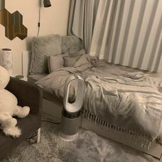 a white teddy bear sitting on top of a chair next to a bed