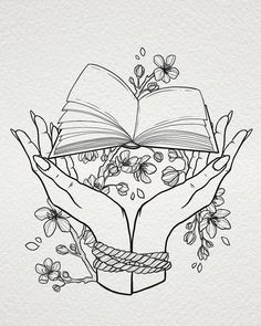 two hands holding an open book with flowers and vines around it on a white background