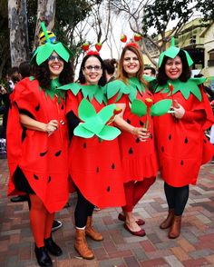 three women dressed in costumes standing next to each other