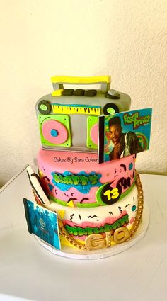 a birthday cake made to look like an old school boombox with cd's on top