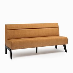 a brown couch sitting on top of a wooden frame