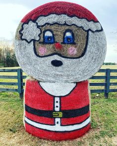 a christmas decoration made out of hay with santa clause on it's head and eyes