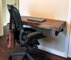 an office chair sitting next to a desk with a laptop on it