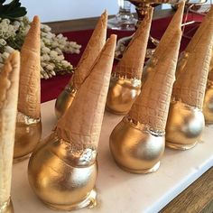 some gold colored cones are sitting on a table