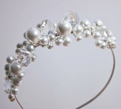 a white headband with pearls and crystal beads