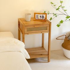 a small wooden table sitting next to a bed