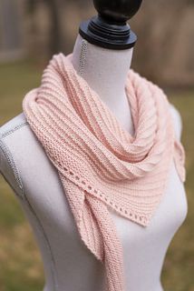 a white mannequin with a pink scarf on it