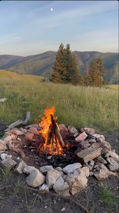 an open fire pit in the middle of a field