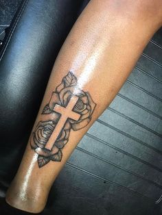 a person with a cross tattoo on their leg