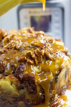 a close up of a piece of cake on a plate with pecans in the background