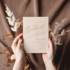 two hands holding up a wedding card