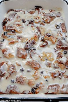 a casserole dish with raisins and cream in it