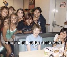 a group of young people posing for a photo in front of a restaurant booth with the caption help i'm still at the restaurant