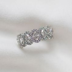 three stone diamond ring on white cloth