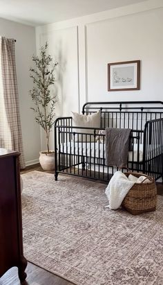 Dark Floor Nursery Ideas, Creamy White Nursery, Nursery Couch Ideas, Nursery Rug Placement Layout, Nursery Ideas Renter Friendly, Neutral Cozy Nursery, Black Trim Nursery, Nursery Walls Ideas, Nursery Simple Neutral