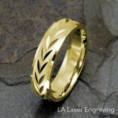 a yellow gold wedding ring with leaves on the inside and inlayed to it