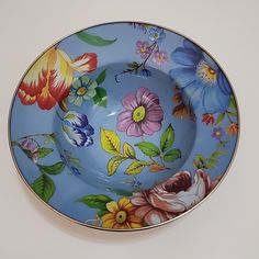 a blue bowl with flowers painted on it