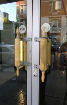 the door handle is made out of wood and has buttons on each side that say putt