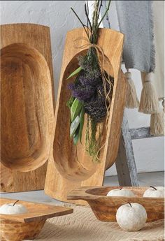 wooden bowls and spoons with flowers in them